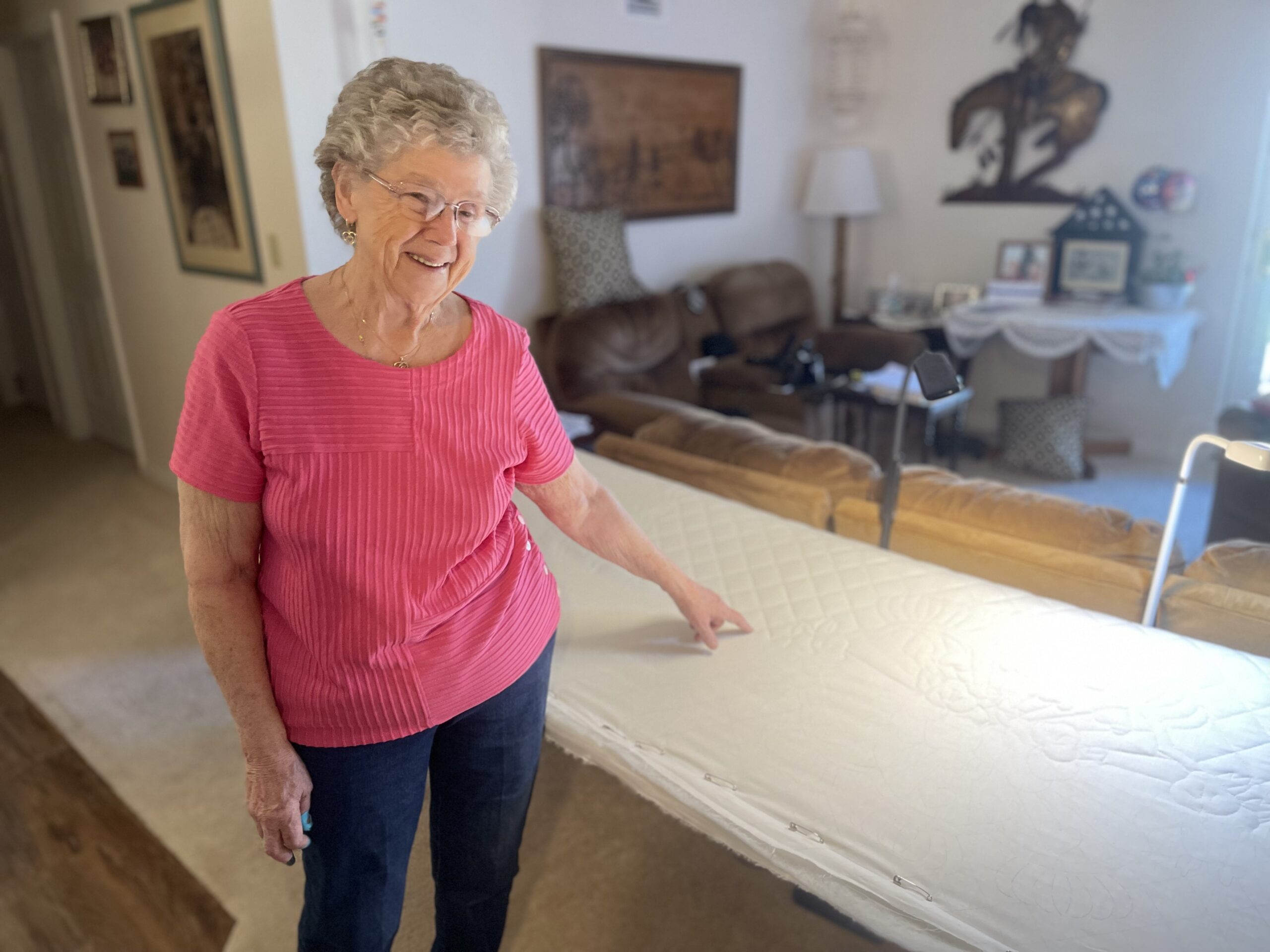Concordia resident Flo Bump stands next to the all white quilt she made