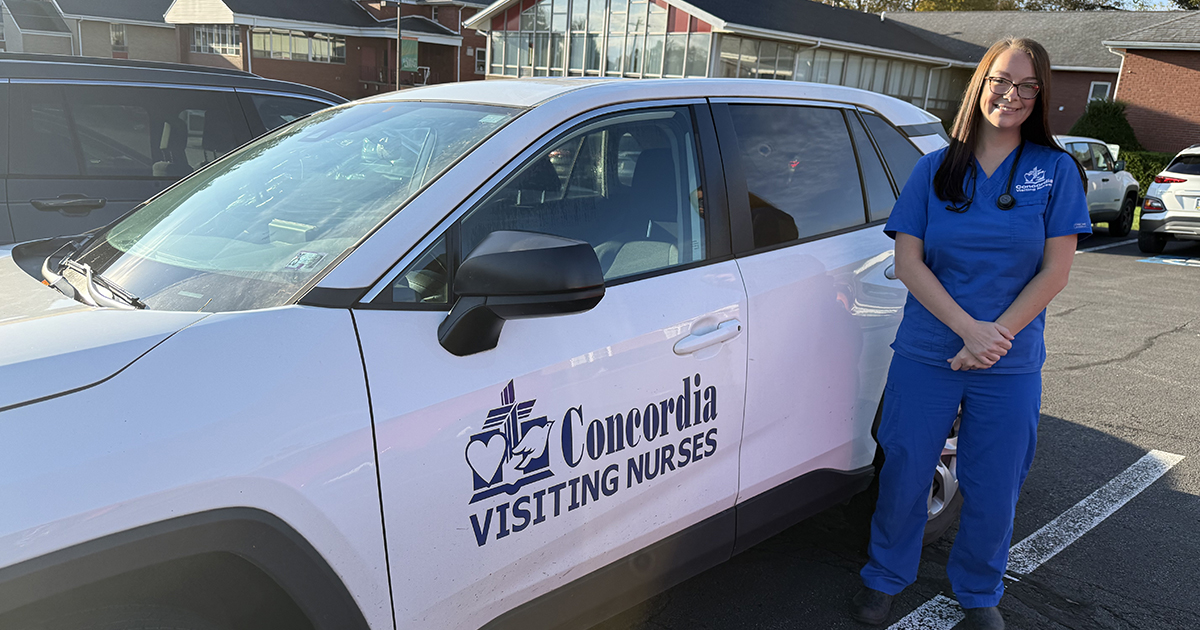 Concordia Visiting Nurses team member Mya Varner standing in front of her car.